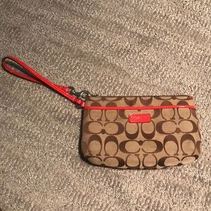 Coach wristlet with red detailing